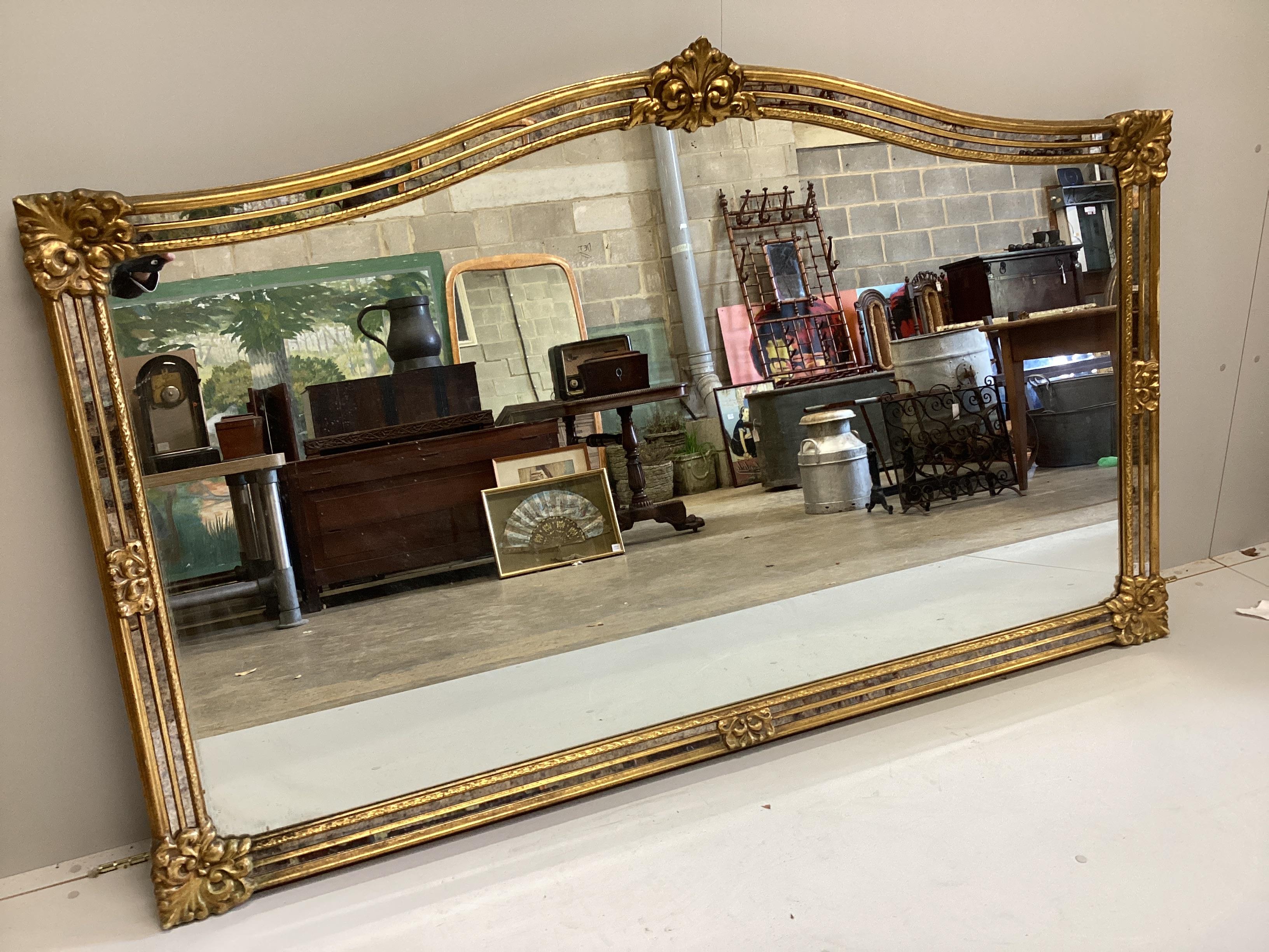 A Venetian style gilt framed overmantel mirror, width 184cm, height 114cm